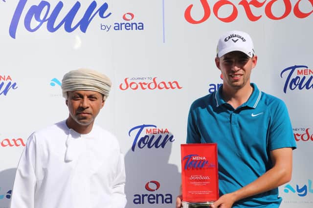 England's Bailey Gill receives the trophy after his one-shot win in the MENA Tour by Arena event
