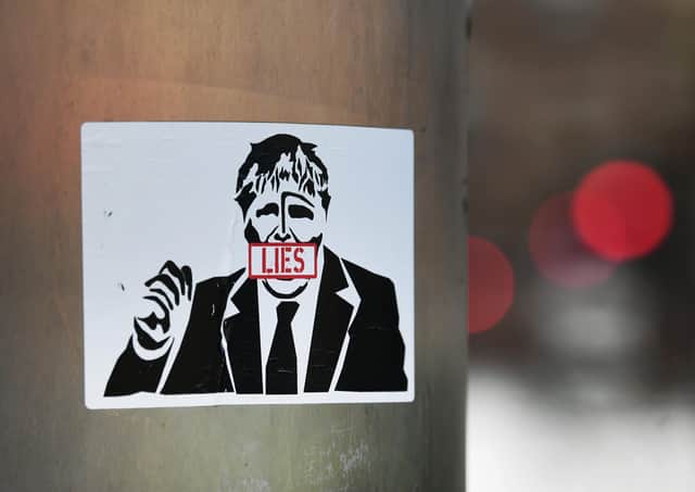 A sticker of Boris Johnson, outside Glasgow City Chambers, casts doubt on the Prime Minister’s truthfulness (Picture: John Devlin)