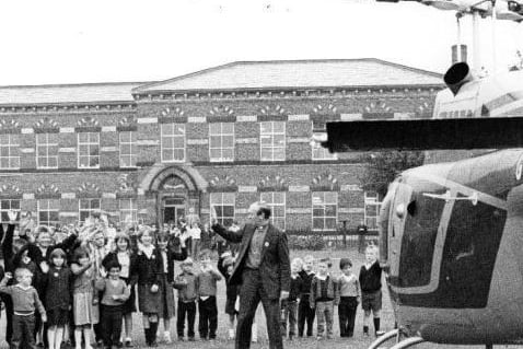 This press photograph shows David Hope, the Archbishop of York is visiting Northgate school in a helicopter.