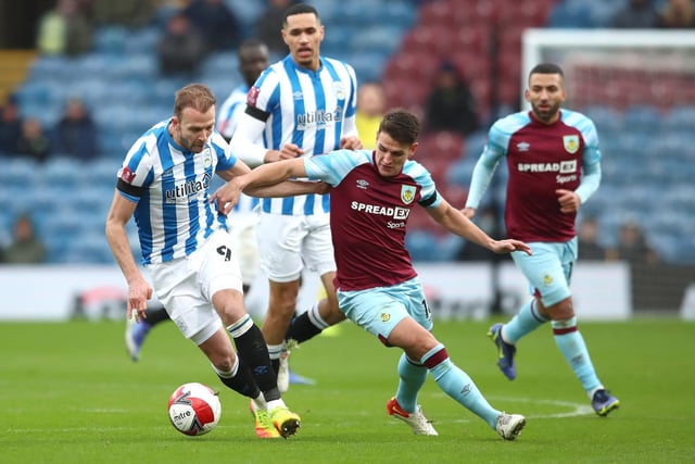Jordan Rhodes of Huddersfield Town battles for possession with Ashley Westwood of Burnley during the Emirates FA Cup Third Round match between Burnley and Huddersfield Town at Turf Moor on January 08, 2022 in Burnley, England.