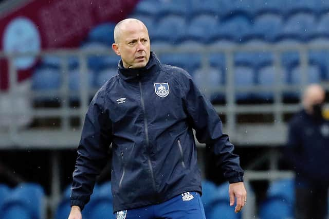 Burnley assistant manager Ian Woan leads the players through their pre-match warm-ups in the absence due to Covid of manager Sean Dyche.