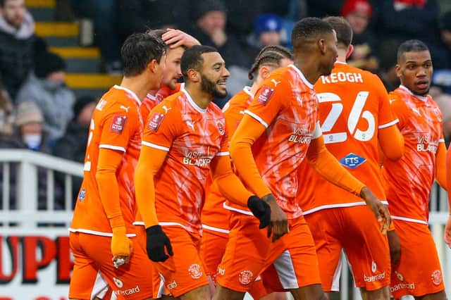 The Blackpool players celebrate Keshi Anderson's goal.