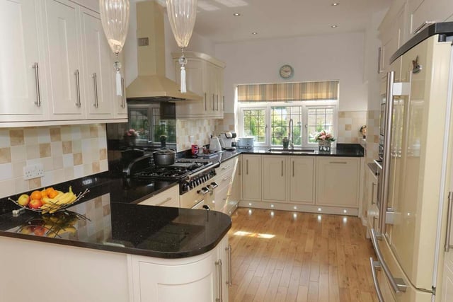 Kitchen appliances include a rangemaster double bowl sink unit with telescopic mixer tap, a Rangemaster multi fuel cooking range with extractor hood above, a self-cleaning electric AEG oven, an AEG fridge freezer, dishwasher and microwave/combination oven.