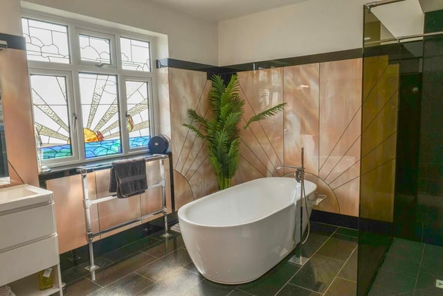 An original window design adds to the considerable stylishness of this house bathroom.