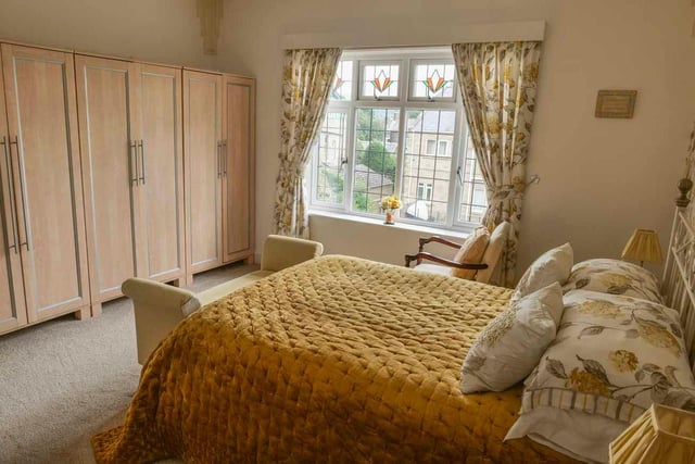 The window is an attractive feature of this bedroom, while allowing in plenty of natural light.