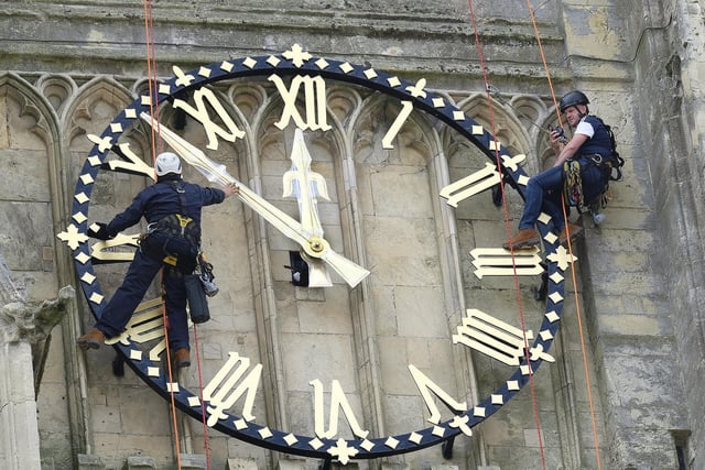 Beverley Minster has its clock hands returned to the clock face after restoration work.