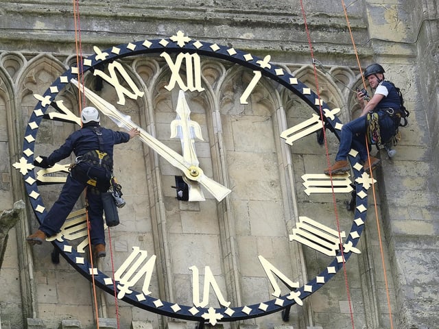 Beverley Minster has its clock hands returned to the clock face after restoration work.