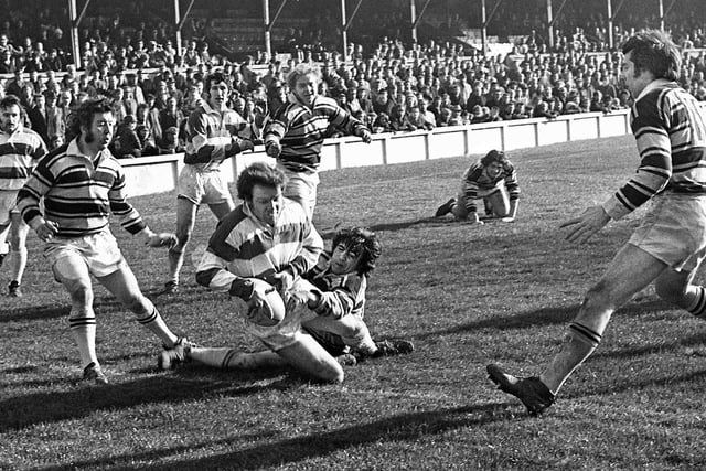 Wigan stand-off David Hill goes over for a try against Hull with Steve Burke and Billy Davies watching in a league match at Central Park on Sunday 12th of March 1972.
Wigan won the game 48-5.