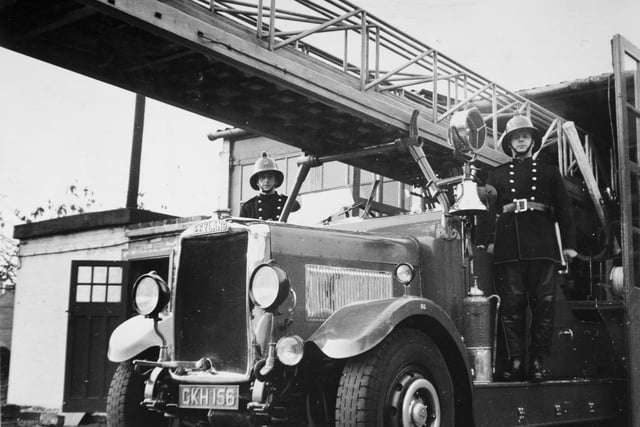 Members of Dewsbury Fire Brigade stand by a 22 year old turntable fire engine. The fire engine saw service in Hull during the Nazi blitzes and was damaged by shrapnel. It is one of four built in 1939, and has a 53 h.p. engine.