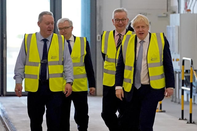 Prime Minister Boris Johnson (right) and Communities Secretary Michael Gove (second right) during a visit to Blackpool Transport Depot.