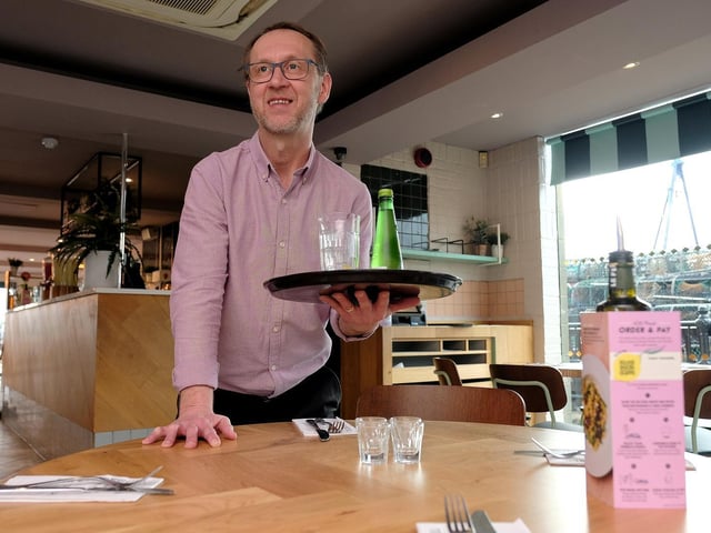 Andy Holmes serving a drink