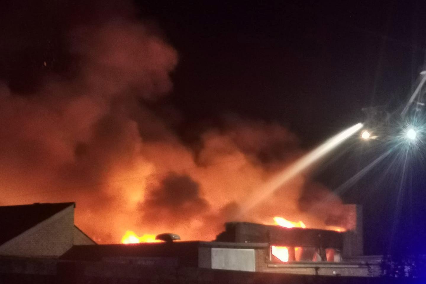 Firefighters use an aerial platform to tackle the blaze. Photo: Tanya Ross