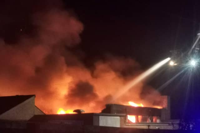 Firefighters use an aerial platform to tackle the blaze. Photo: Tanya Ross