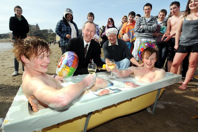 Twins Matthew and William Wild celebrate their birthday with grandfather Freddie Drabble, The Sons of Neptune, and about 40 of their friends. William, left, and Matthew enjoy a warm bath after their swim.