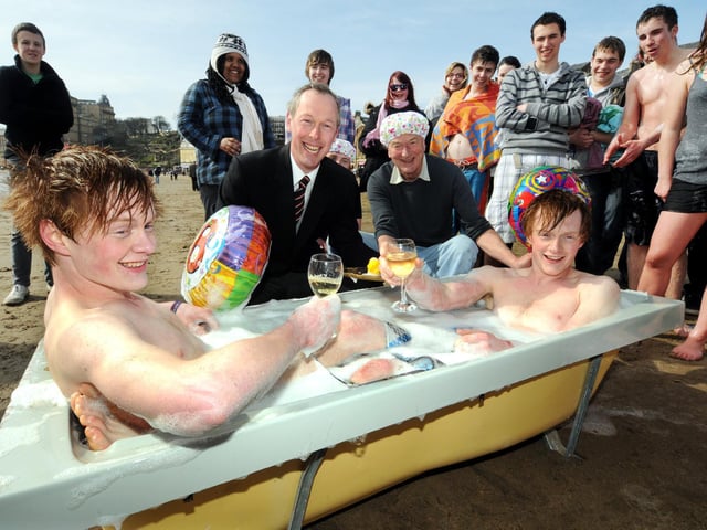 Twins Matthew and William Wild celebrate their birthday with grandfather Freddie Drabble, The Sons of Neptune, and about 40 of their friends. William, left, and Matthew enjoy a warm bath after their swim.