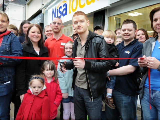 Coronation Street actor Mikey North, centre, cuts the ribbon to officially open the new Nisa store with Veronica Wilson, Craig Wilson and Daniel Wilson.