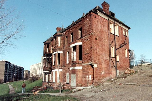 A man with his dog walk across a field near the now demolished Old Bank Club which used to stand on top of Cavalier Hill. Mount St Mary's High School can be seen in the background.