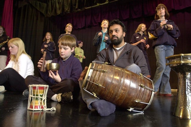 Manjeet Singh a musician with Opera North rehearses with Mark Broadhead of Earlsheaton High School and other children as they prepare their production of Madam Butterfly at Dewsbury Arts Centre. 2000.