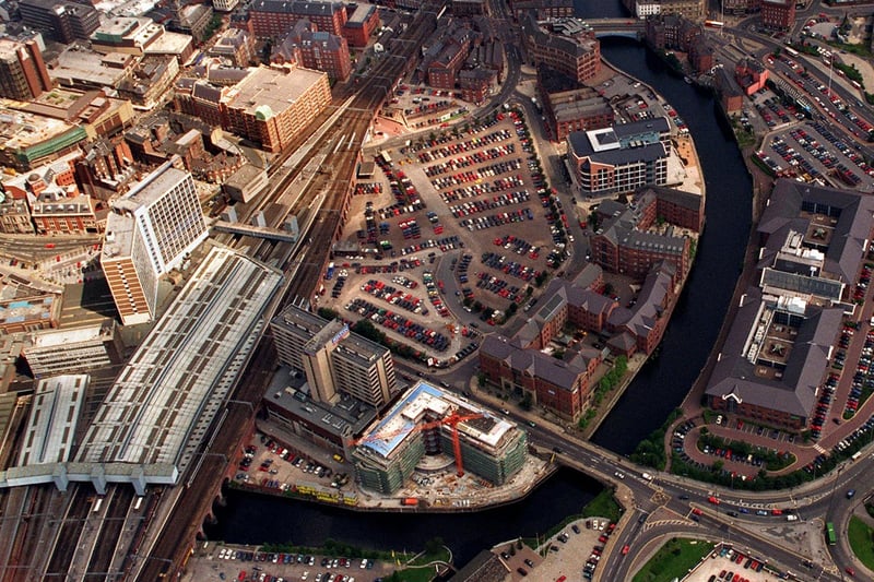 City Station and City House (left) with the River Aire meanders under Victoria Bridge, (foreground), and Leeds Bridge (top of picture).