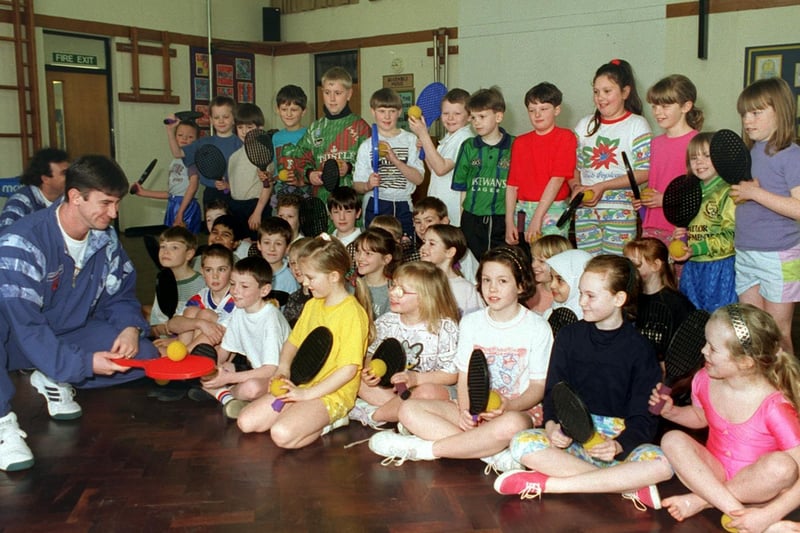 Pupils of St Saviour's Junior School on Upper Batley Lane took part in the Cliff Richard Tennis Trail in March 1996. Professional tennis coach Paul Regan gets down to basics with the group.