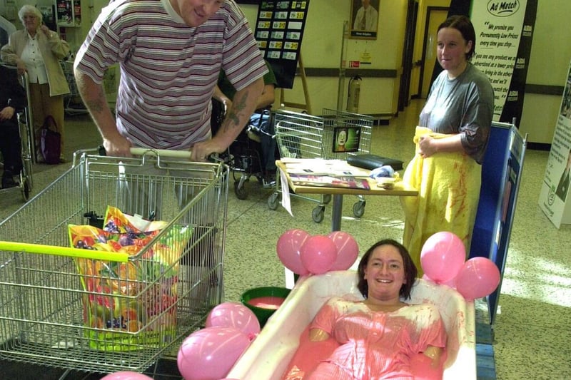 The ASDA store at Killingbeck had gone literally pink for two weeks for the supermarket's annual Tickled Pink Campaign. Pictured is supermarket assistant Sarah Gregson bathing in a bath of blancmange.