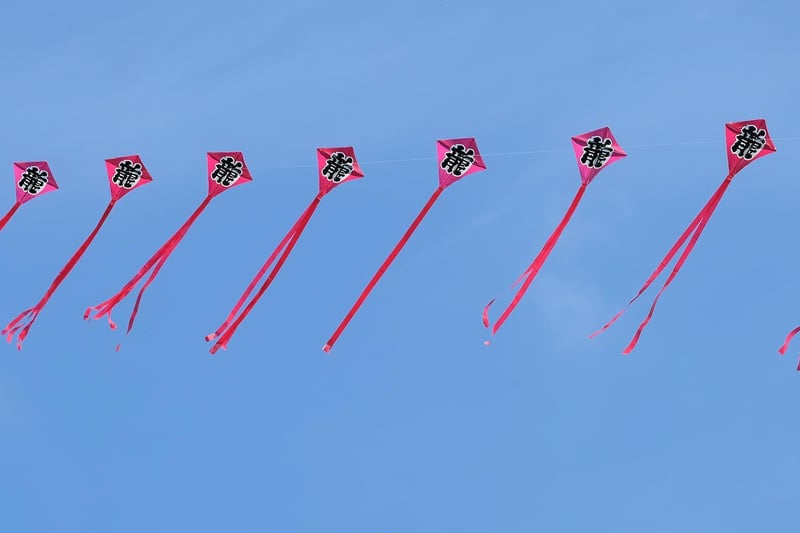 A string of kites in flight.