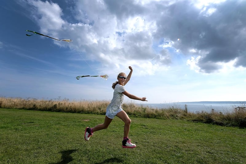 Chloe Helmn races her kite.