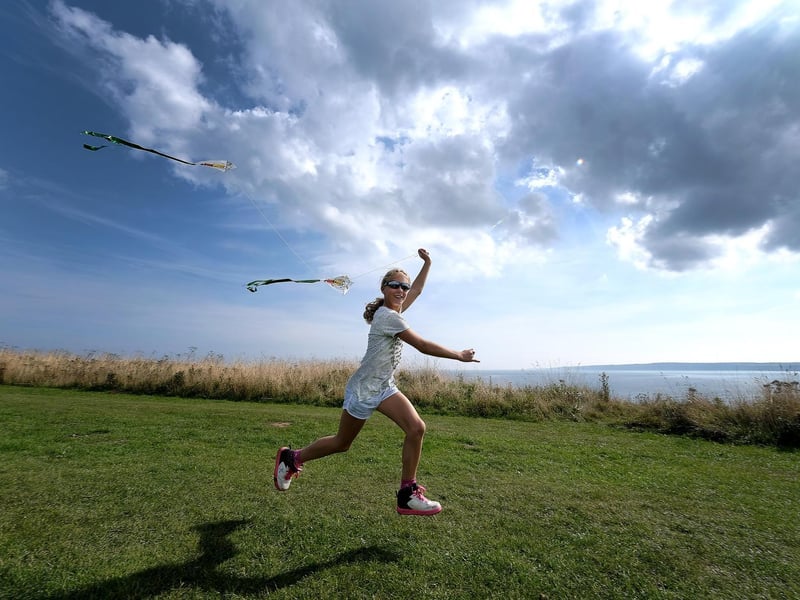 Chloe Helmn races her kite.