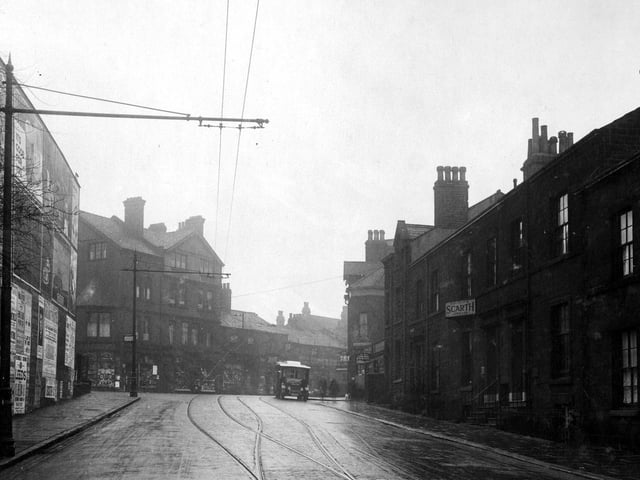 Headingley's Victoria Road in February 1930 looking towards Hyde Park Corner. The road is part cobbled and has tram lines. Overhead tram wires can be seen