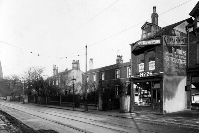 Headingley Lane in November 1937. Spink and Simpson plumbers and electricians are pictured. To the left is residence and office of Joseph Leonard Iredale surgeon.
