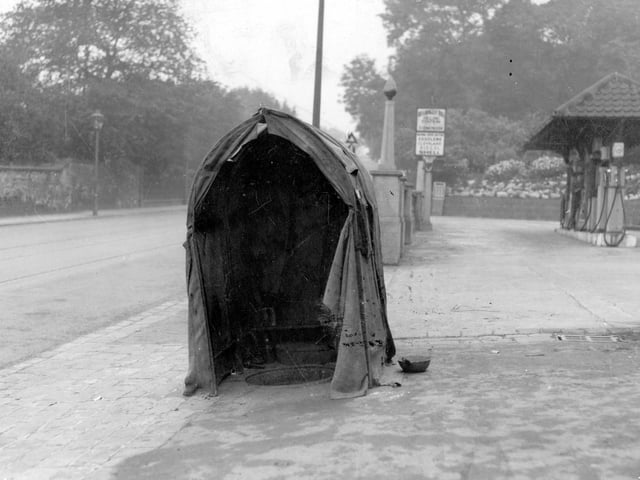 A garage forecourt premises of S.Wells on Headingley Lane, junction with North Hill Road. petrol pumps under canopy. Telephone repair shelter.
