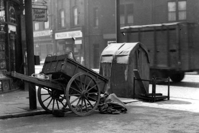 A handcart and telephone repair shelter on junction of Regent Park Avenue with Headingley Lane in July 1936. William Crosswaite butchers and Walter Barker, grocers can be seen on the right.