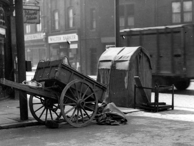 A handcart and telephone repair shelter on junction of Regent Park Avenue with Headingley Lane in July 1936. William Crosswaite butchers and Walter Barker, grocers can be seen on the right.
