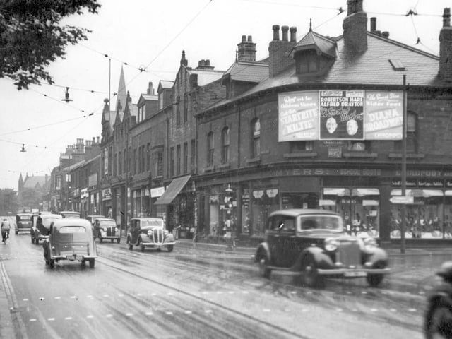 Otley Road looking towards junction with North Lane in June 1937. Shoppers and Motor vehicles can be seen on the street. Myers store can be seen on the left.