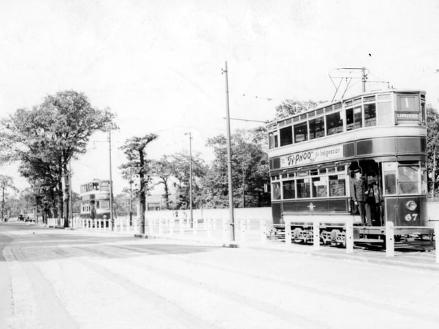 Two trams travelling along Otley Road in the direction of Lawnswood in July 1939. The view looks back towards the Shaw Lane area of Headingley.