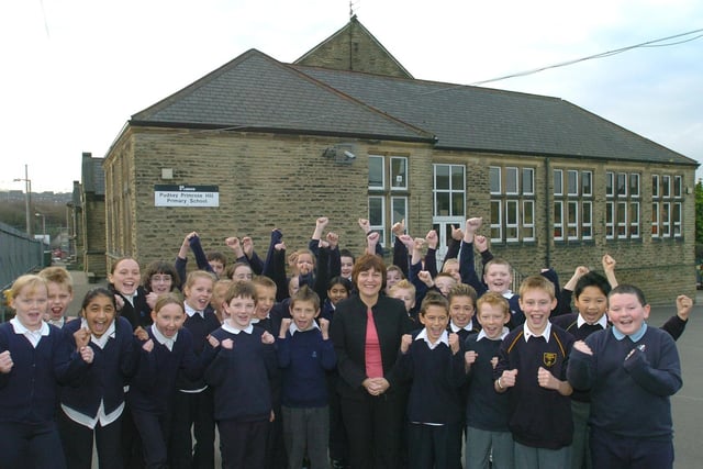 Headteacher Lesley West is pictured with cheering pupils at Pudsey Primrose Hill after the school was named a top primary in Leeds.