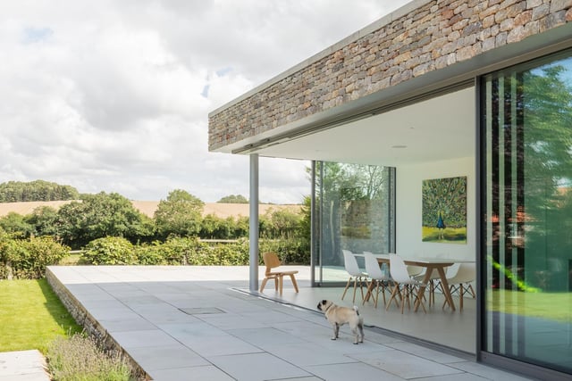 Sliding doors open to bring the outside in, which is perfect on hot summer days