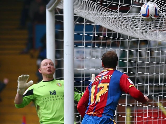 Crystal Palace striker Glenn Murray scores past Paddy Kenny during the Championship clash at Selhurst Park in March 2013.