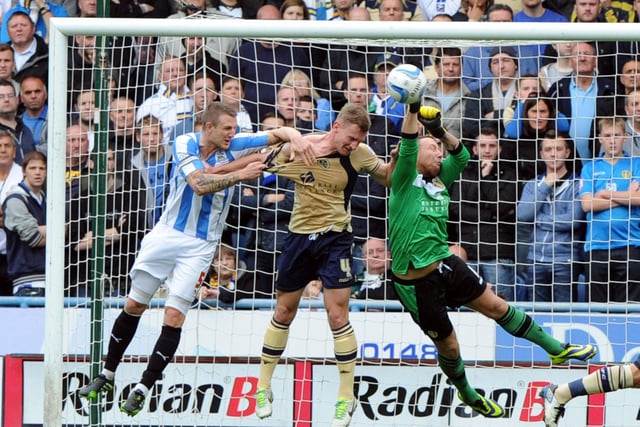 Paddy Kenny punches clear during Leeds United's Championship clash with Huddersfield Town at the John Smith's Stadium in October 2013. The Whites lost 3-2.