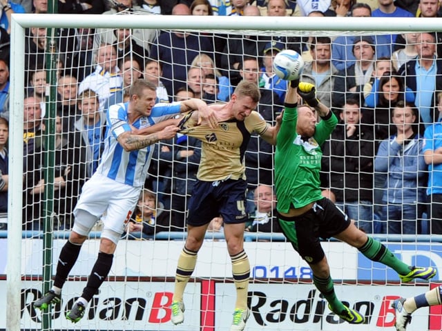 Paddy Kenny punches clear during Leeds United's Championship clash with Huddersfield Town at the John Smith's Stadium in October 2013. The Whites lost 3-2.
