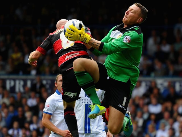 Paddy Kenny claims the ball under pressure from Queens Park Rangers striker Andrew Johnson during the Championship clash in August 2013.