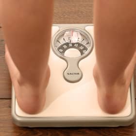 An 11-year-old girl using a set of weighing scales. Picture: Chris Radburn/PA Wire