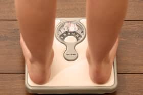 An 11-year-old girl using a set of weighing scales. Picture: Chris Radburn/PA Wire