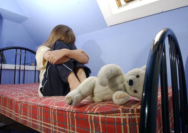 STOCK, Child neglect, 11/10/03: Neglected child (Picture posed by model, with parents's permission). Child neglect Children child abuse child abuse teddy bear bear teddy bed attic neglect juvenile parent