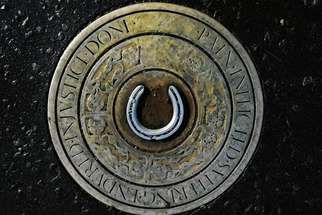 The brass plaque at the Maxwellton Cross in Paisley. Picture: John Devlin