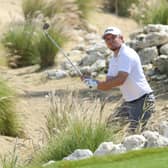 Eddie Pepperell plays out of the rocks at the third hole during the first day of the Qatar Masters. He was later disqualified. Picture: Warren Little/Getty Images