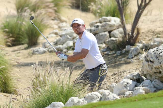Eddie Pepperell plays out of the rocks at the third hole during the first day of the Qatar Masters. He was later disqualified. Picture: Warren Little/Getty Images
