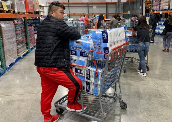 A man prepares to buy 150 rolls of toilet paper at a store in Los Angeles (Picture: Mark Ralston/AFP via Getty Images)