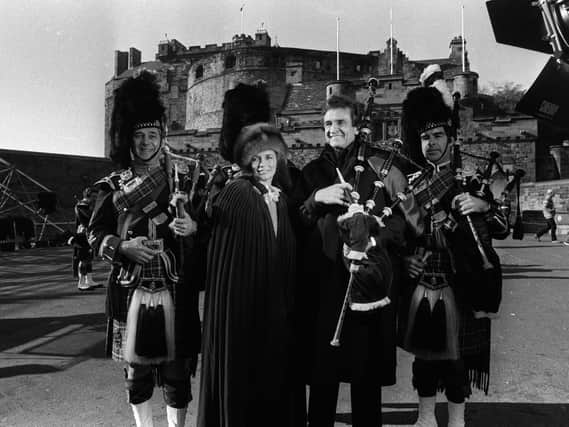 Johnny Cash and his wife June at Edinburgh Castle in 1981. Cash travelled to Scotland to explore his Fife roots during the 1980s and on this trip they made a television show "Christmas in Scotland". PIC: TSPL.