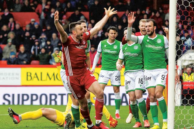 Andrew Considine celebrates putting Aberdeen ahead against Hibernian. Picture: Paul Devlin / SNS